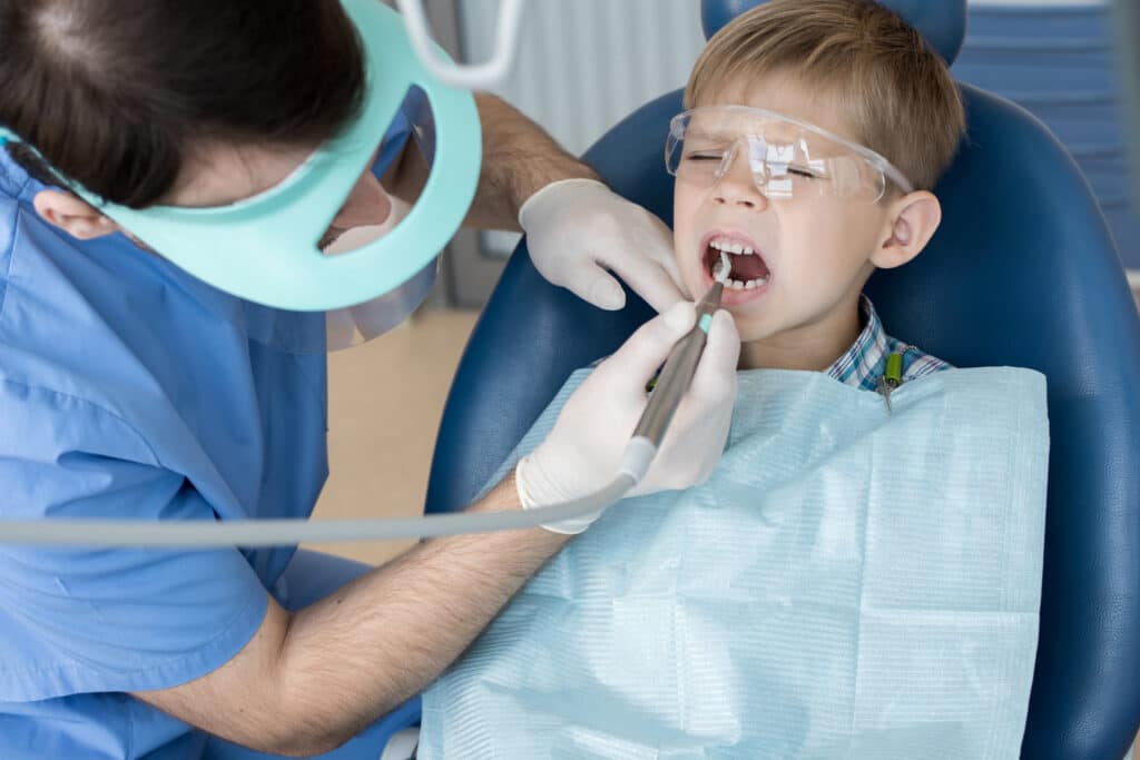 Child visiting the dentist undergoing a dental procedure