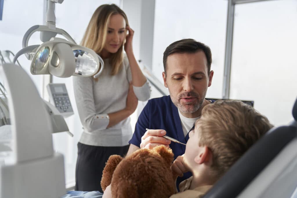 Family dentist working with a young child