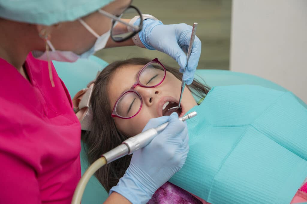 Pediatric dental patient that is getting their teeth cleaned