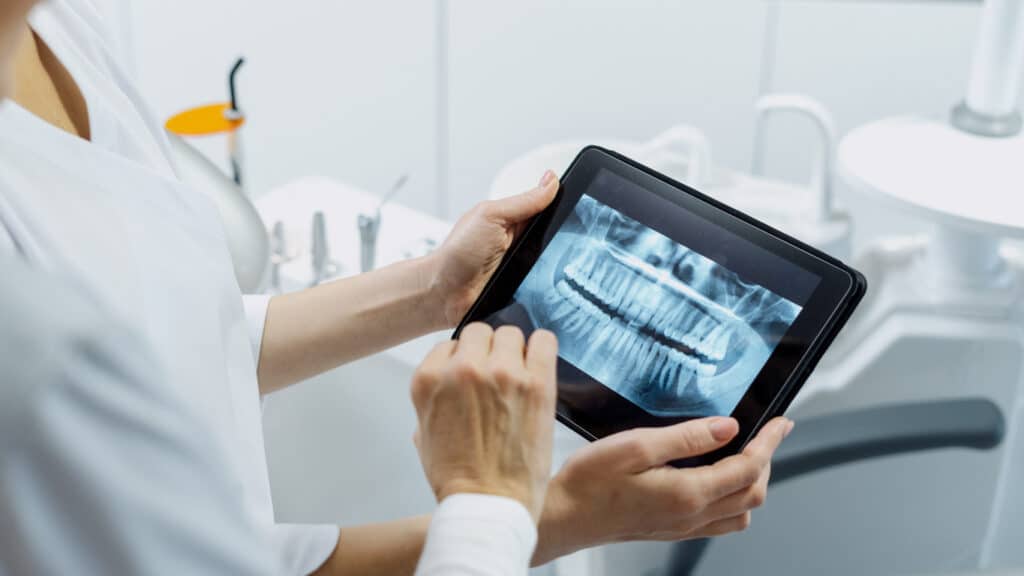 Dentist examining a patients dental x-rays