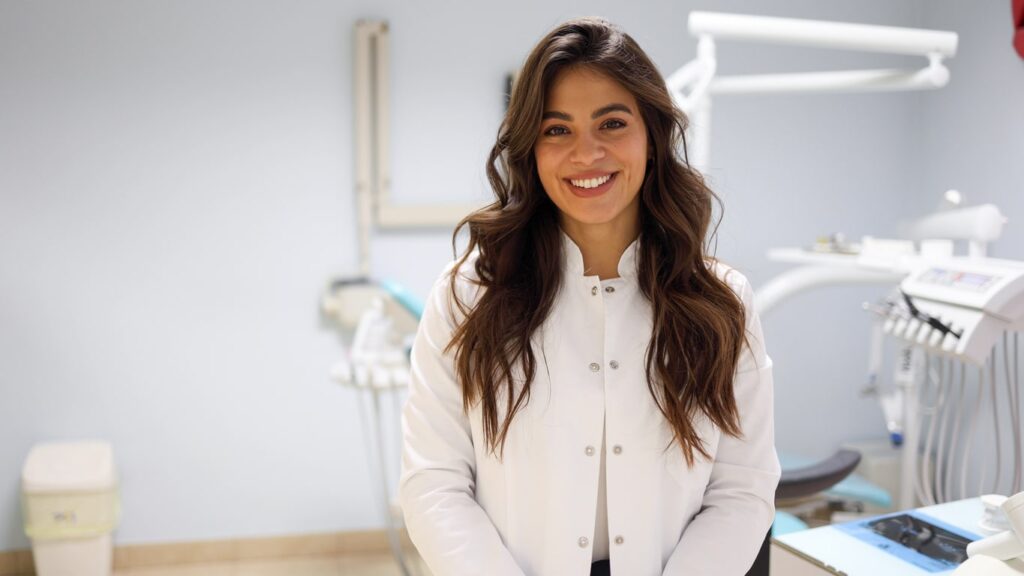 Dentist smiling in the office, helping you save money